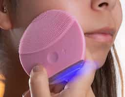 Massageador facial produzido em silicone resistente a água, a escova possui cerdas macias que limpam e massageiam a face. Sua parte frontal possui um botão de acionamento, além de dois botões para alteração entre os 6 modos de intensidade. A limpeza da face através do uso do produto, limpa profundamente os poros melhorando vários aspectos da pele, aumentando o fluxo sanguíneo, prevenindo contra rugas e outras impurezas na pele. O produto possui bateria recarregável com Voltagem de 3.7V e Potência de 0.25W. Acompanha cabo USB.