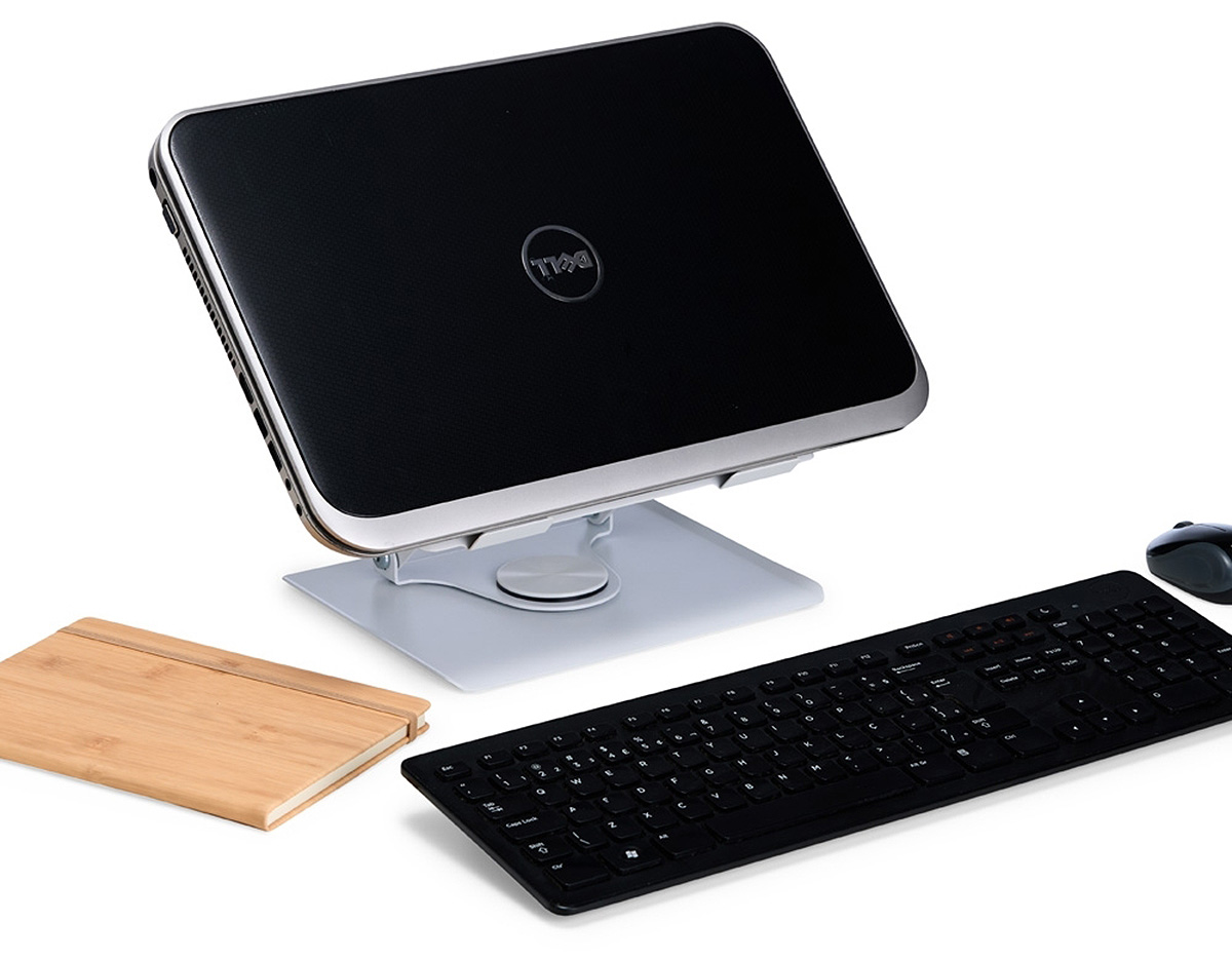Suporte articulado para notebook com ajuste de ângulo e rotação. Em aço, oferece ergonomia, dissipação de calor e tiras antiderrapantes para uso seguro em casa, trabalho ou escola.