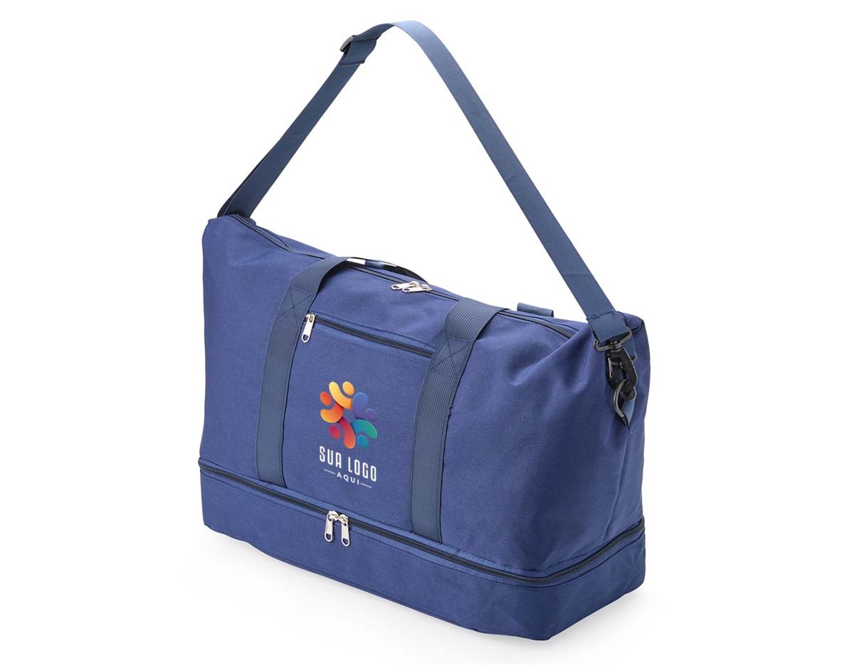 Bolsa multiuso com capacidade de até 19?L, feita em Oxford impermeável. Possui compartimento principal com dois bolsos internos, sendo um com zíper e outro dividido. Conta ainda com bolso externo para pequenos objetos e compartimento inferior com zíper. Acompanha alça transversal removível.